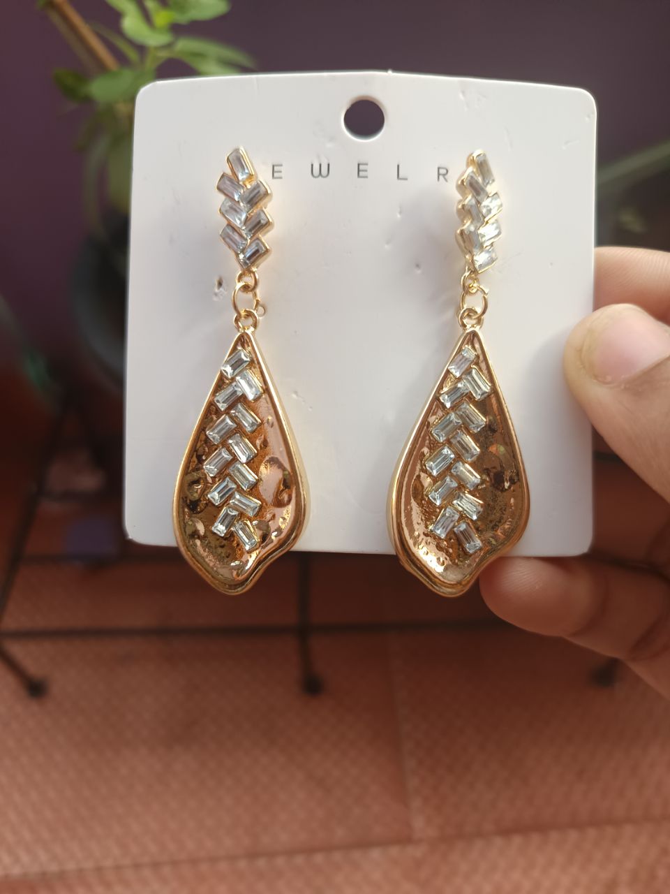 Gold plated drop earring with diamond cut design